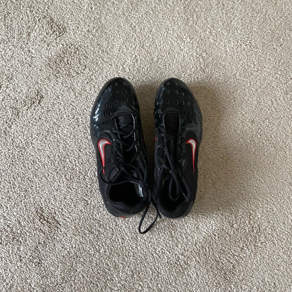 Nike Kids Black track cleats with Red Swoosh Accent